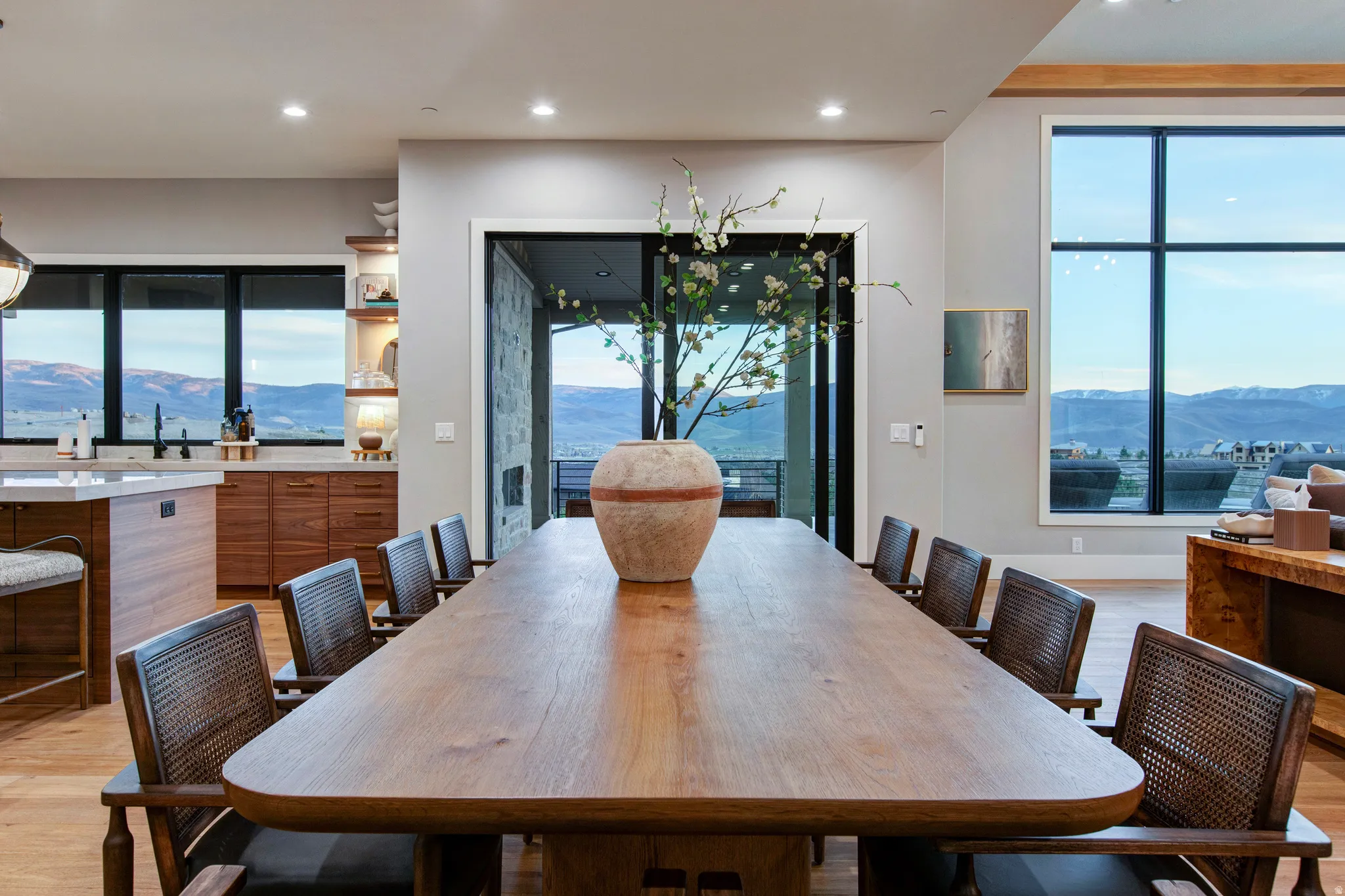 Expansive dining area featuring wood-finish flooring and a large rectangular dining table