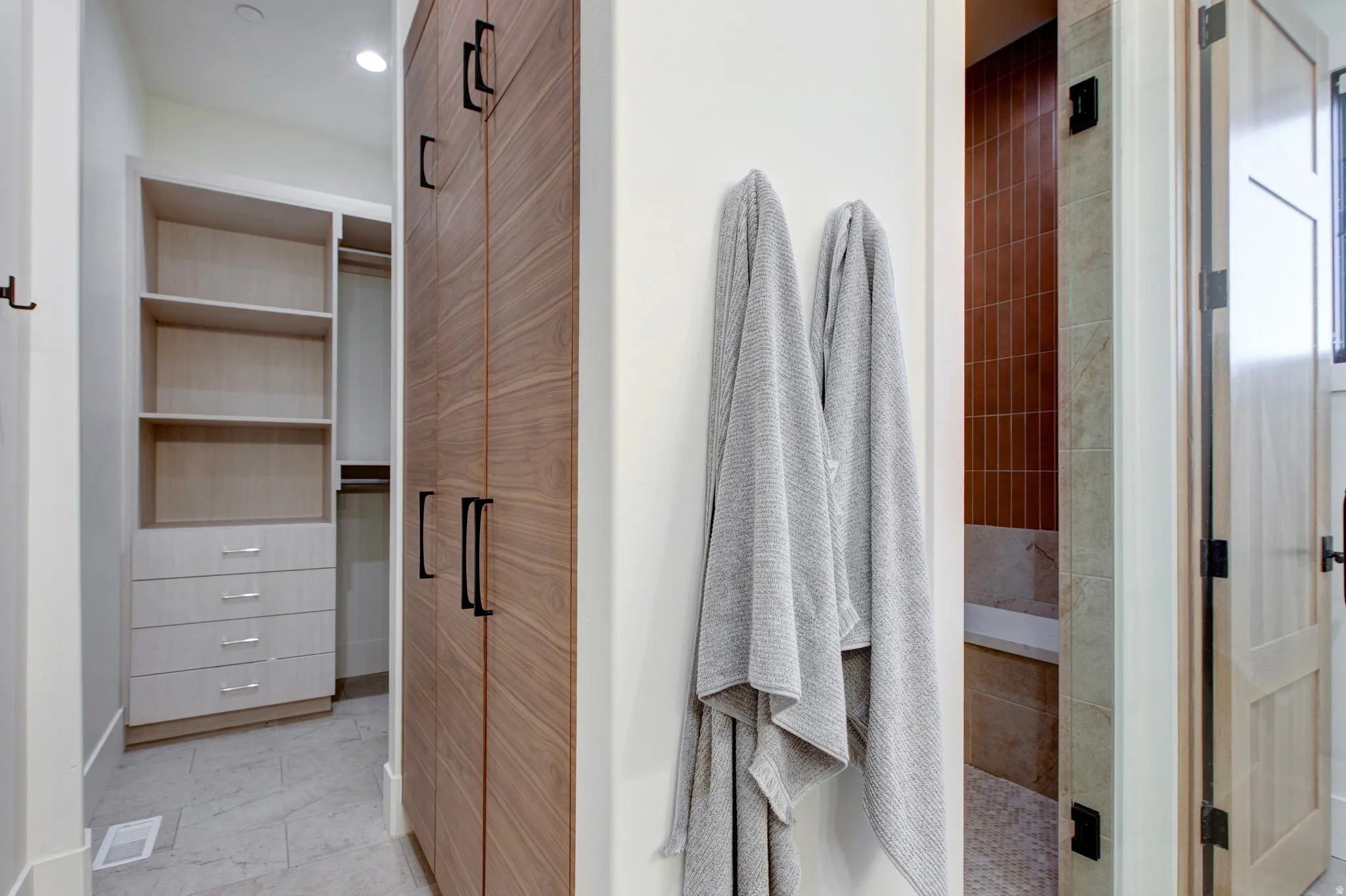 Built-in closet system with open shelving and drawer storage