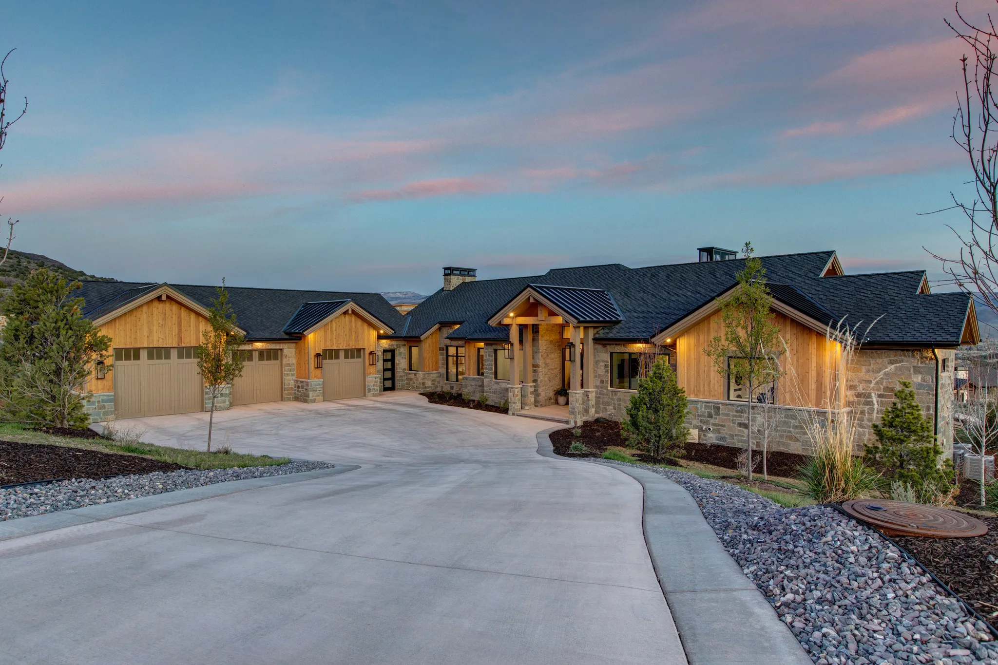 Expansive paved driveway leading to a multi-car garage
