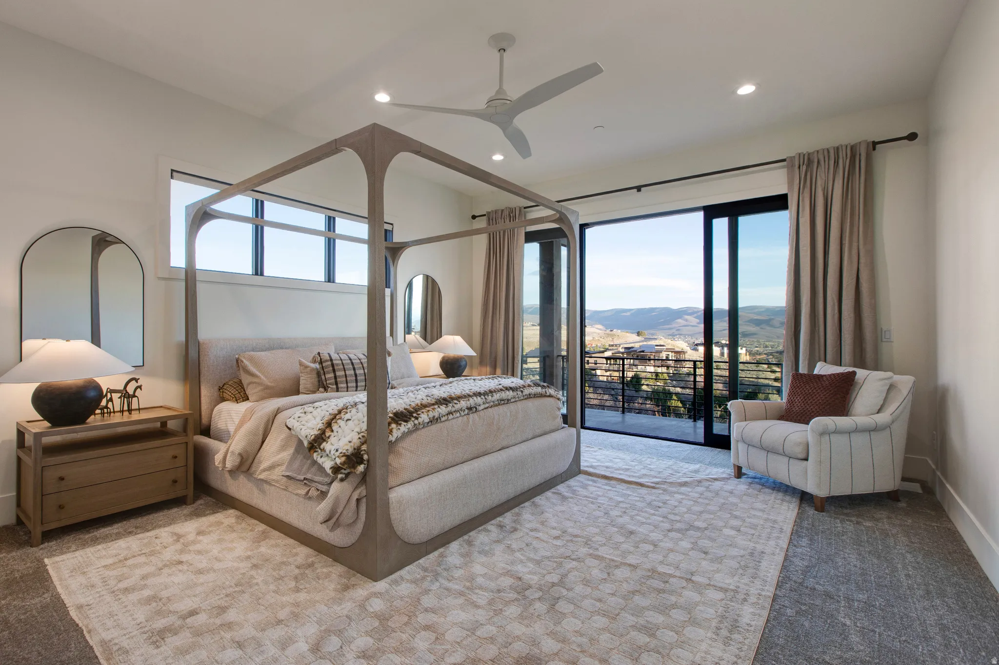 Spacious room featuring a sliding glass door to a balcony, high ceilings, recessed lighting, and a contemporary ceiling fan