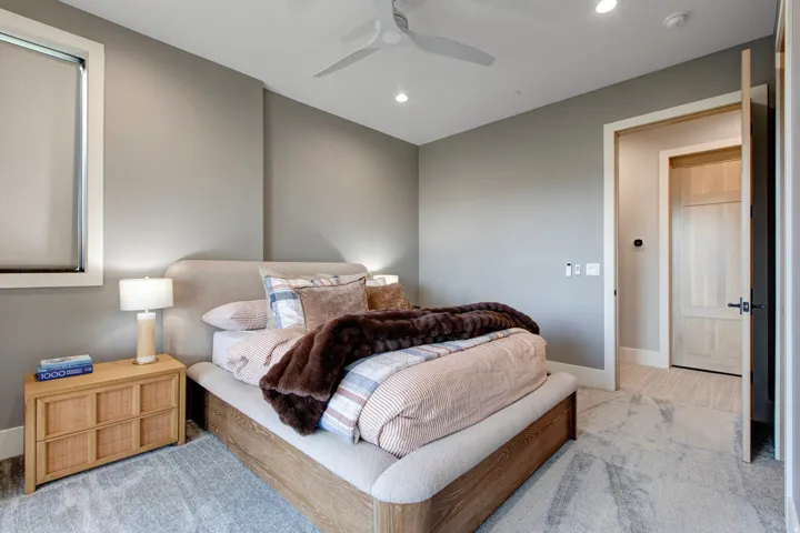 Carpeted room featuring a ceiling fan, recessed lighting, and a neutral color palette