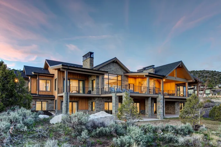 Multi-level residence featuring stone and wood-panel exterior accents