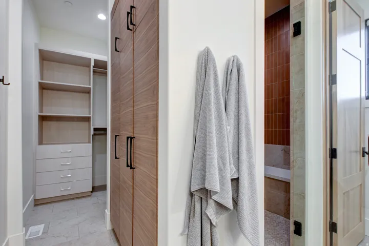 Built-in closet system with open shelving and drawer storage