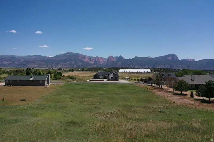 Expansive undeveloped land parcel featuring grass and distant mountain ranges