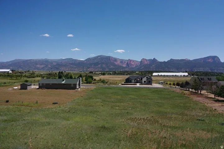Expansive land parcel featuring open fields and distant mountain ranges