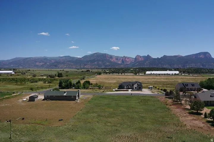 Expansive property with a verdant landscape and distant mountain ranges