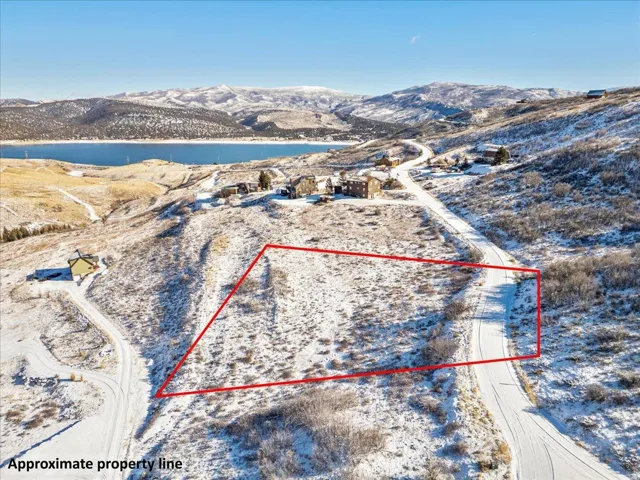 Aerial view of property's location with property parcel outlined and a water and mountain view