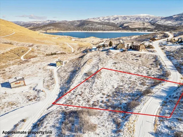 Aerial overview of property's location featuring property parcel outlined and a water and mountain view