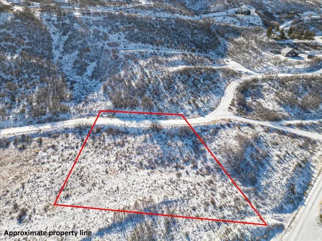 Snowy aerial view featuring property boundaries highlighted