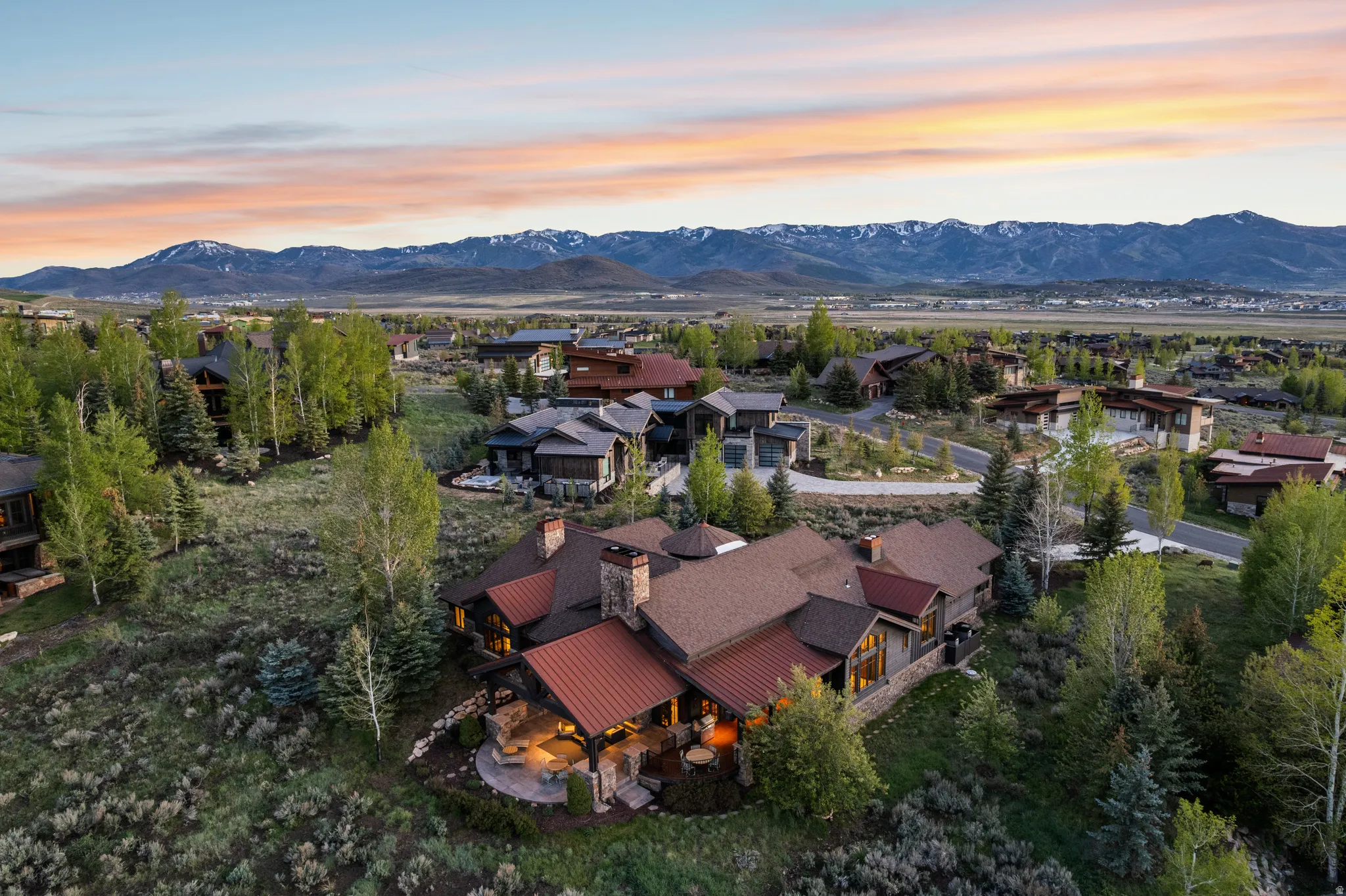 Mountain-modern residence featuring a multi-level design and a prominent metal roof