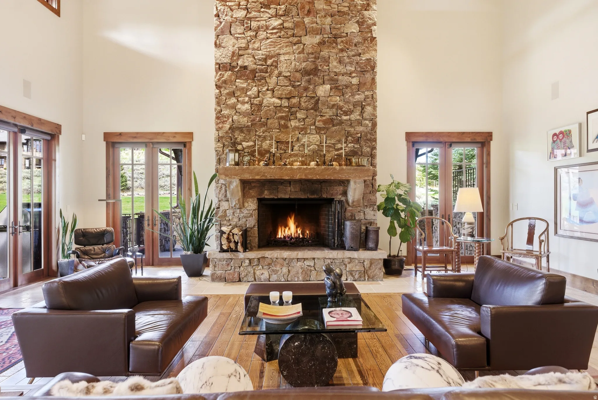 Two-story stacked stone fireplace with a substantial timber mantel