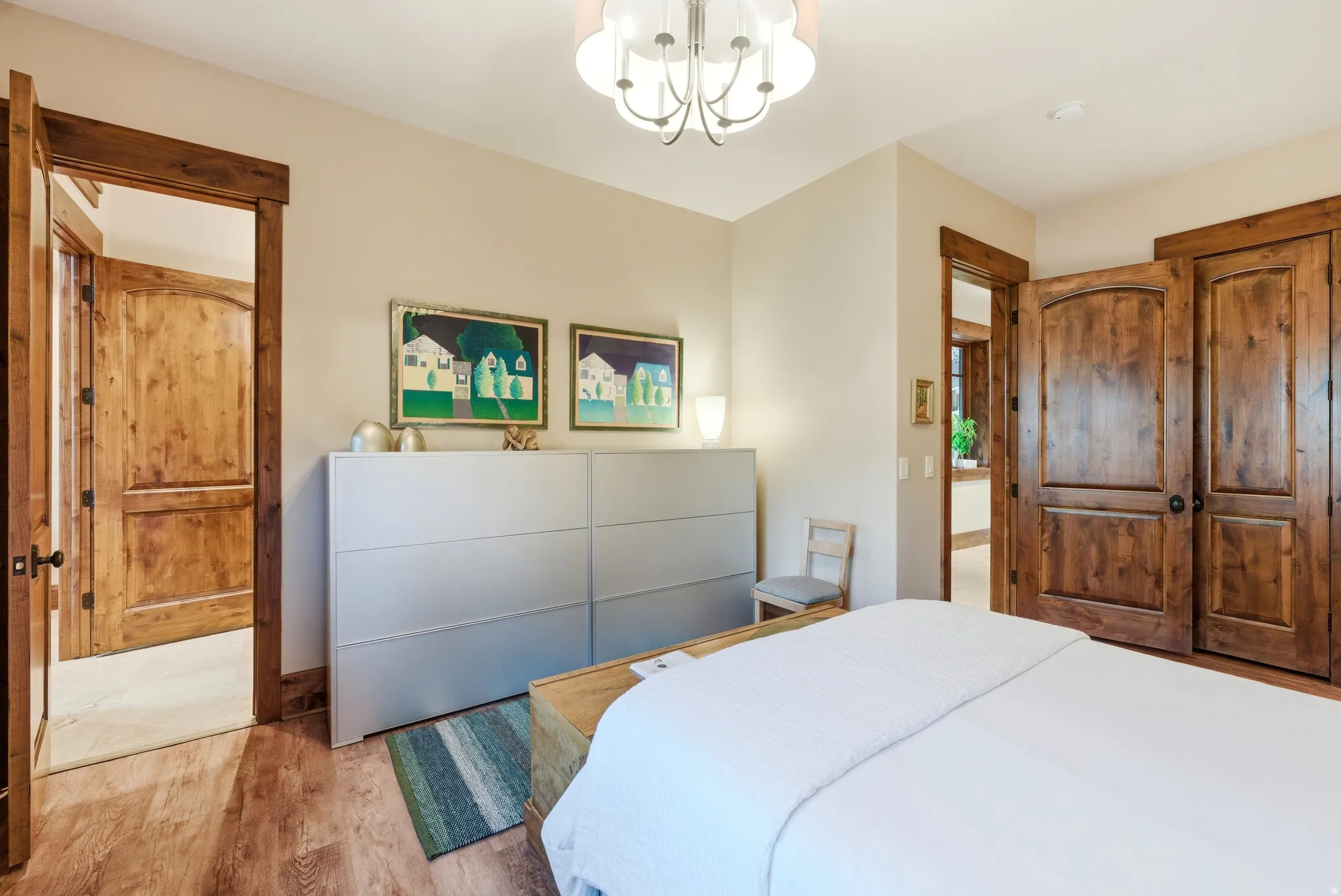 Wood-finish flooring complemented by a decorative ceiling light fixture