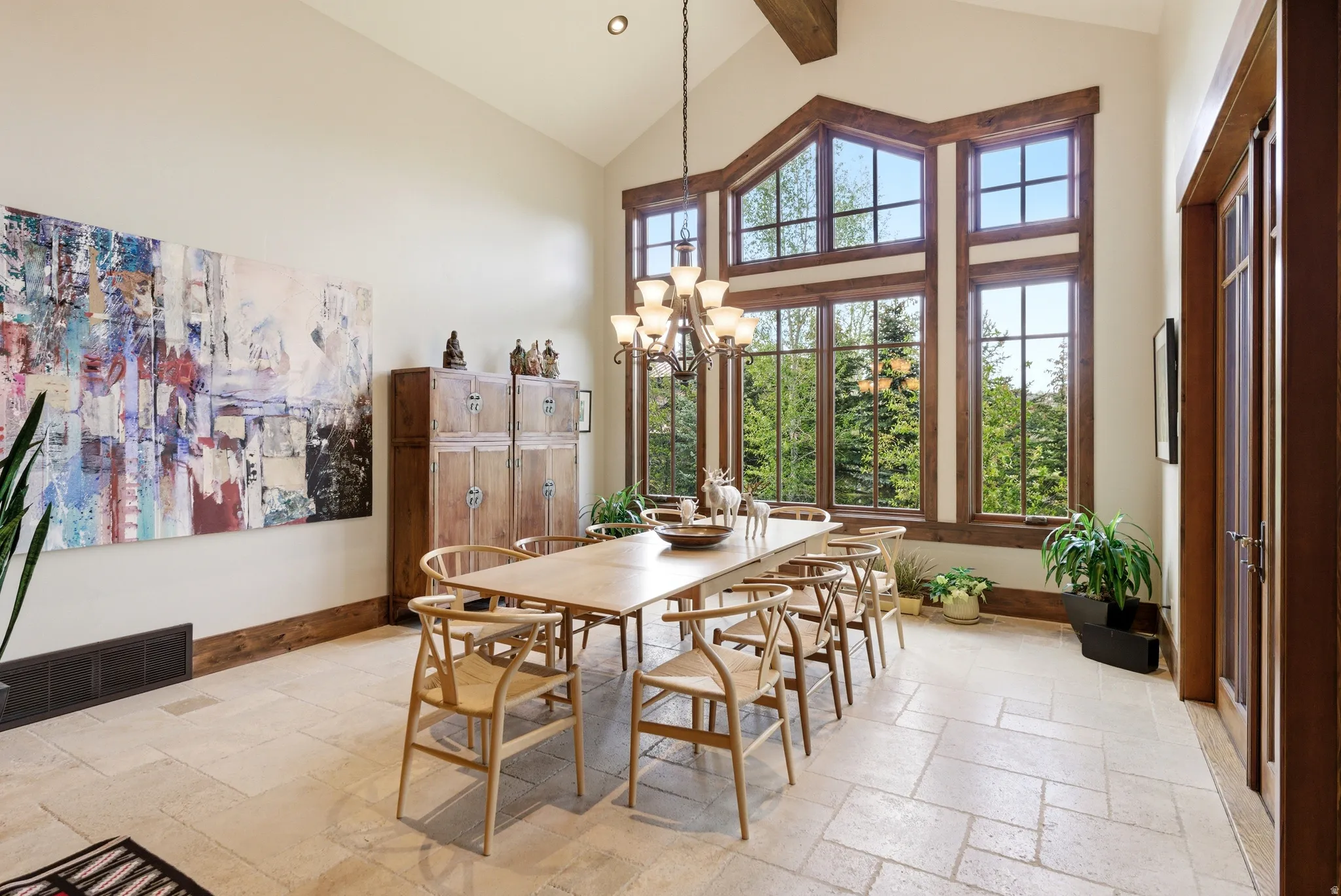 Dining area featuring a vaulted ceiling and extensive natural wood-framed windows