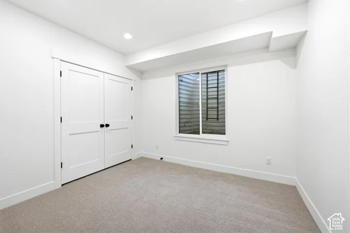 Neutral-toned carpeting complements bright white walls and trim