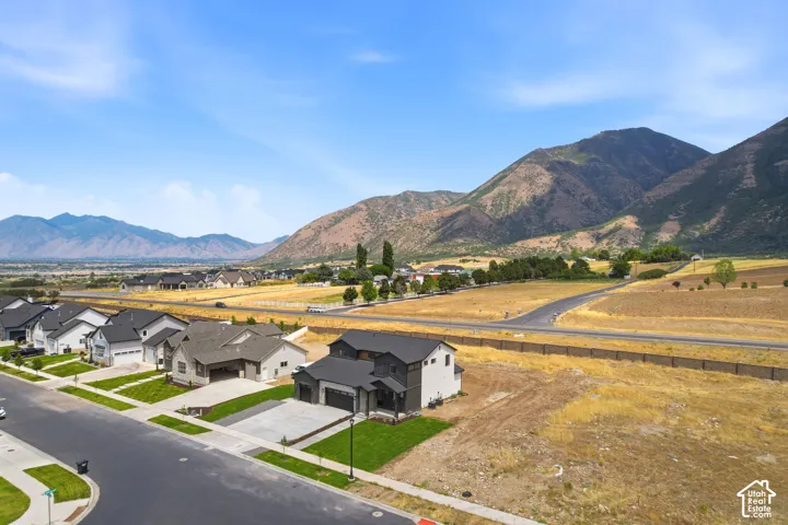 Modern residential development with mountain backdrop and clear skies