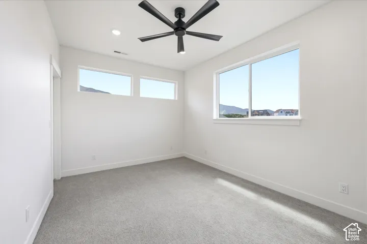 Neutral tone walls with gray carpet flooring