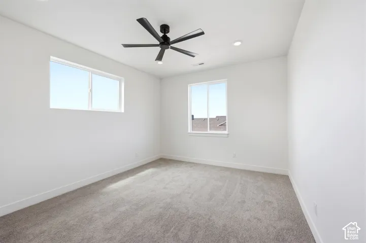Bright room featuring light gray carpeting and white walls