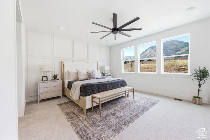 Spacious room featuring a paneled accent wall, recessed lighting, and a modern ceiling fan