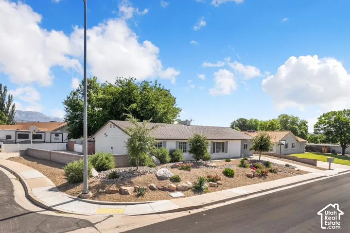 Single-story residence featuring a neutral exterior, a corner lot, and an unattached garage