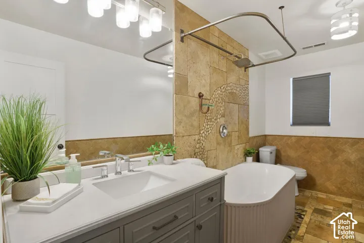 White vanity with a rectangular undermount sink, chrome faucet, and expansive mirror
