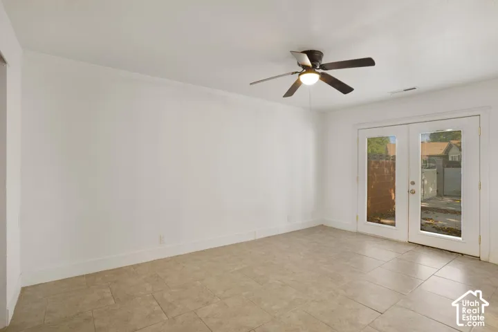 Recessed lighting, ceiling fan, and French doors with expansive glass panels