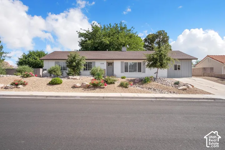 Single-story residence featuring a durable composite shingle roof and a stucco exterior finish