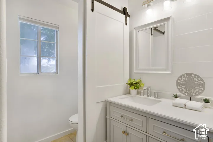 Vanity with white countertop, chrome fixtures, and undermount sink
