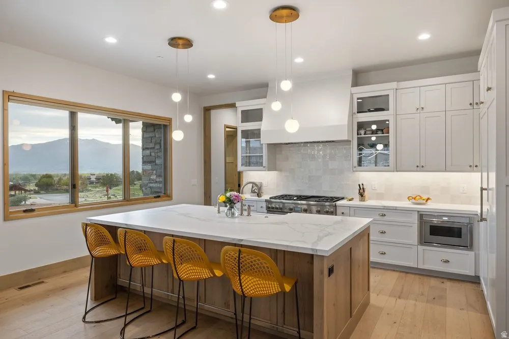 Expansive kitchen island featuring a light-toned wood-finish base and a white countertop with subtle veining