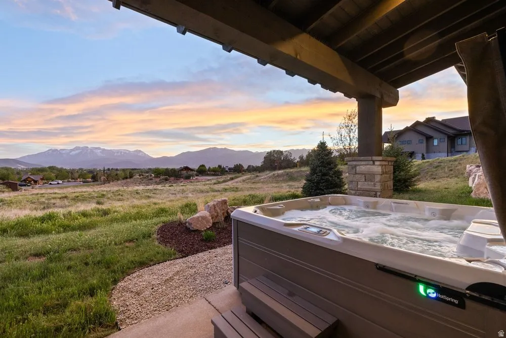 Outdoor hot tub featuring bubbling water and integrated steps