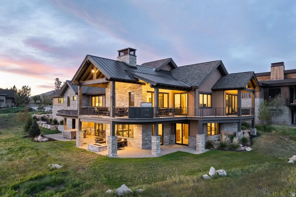 Stone and wood-sided exterior featuring multiple balconies and patios