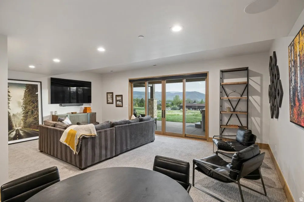 Spacious room featuring light-colored carpeting and recessed ceiling lighting