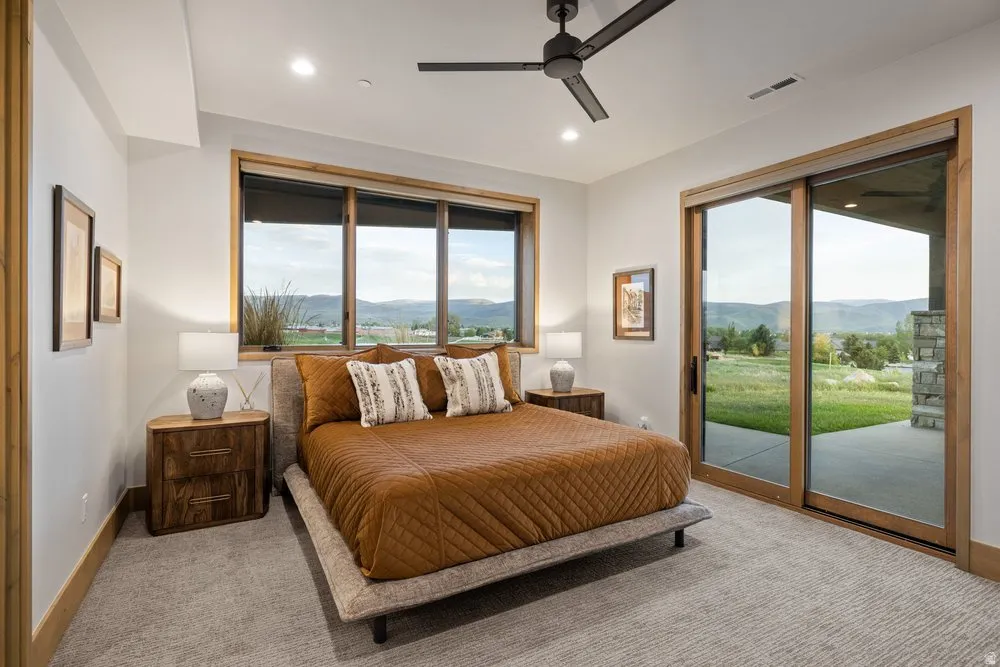 Spacious room featuring a multi-pane window and a glass sliding door, both framed in wood