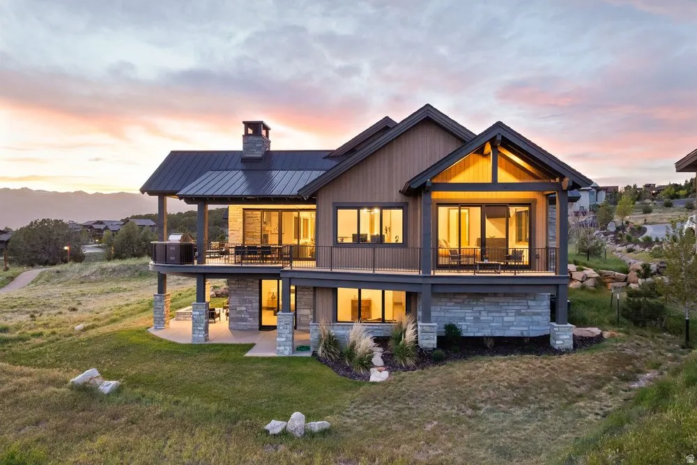 Modern mountain-style exterior with wood siding and stone accents