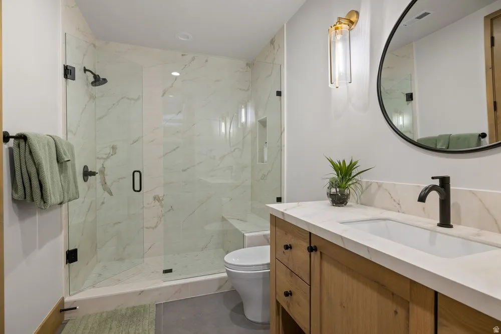 Walk-in shower with clear glass enclosure and built-in bench