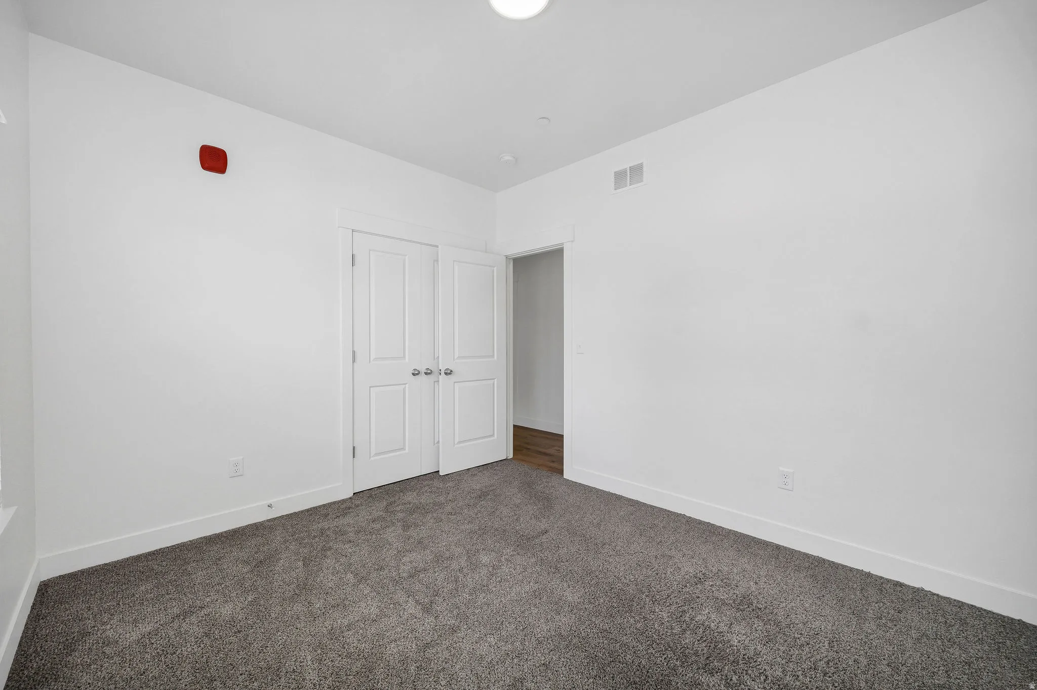 Neutral white walls complemented by a gray carpet