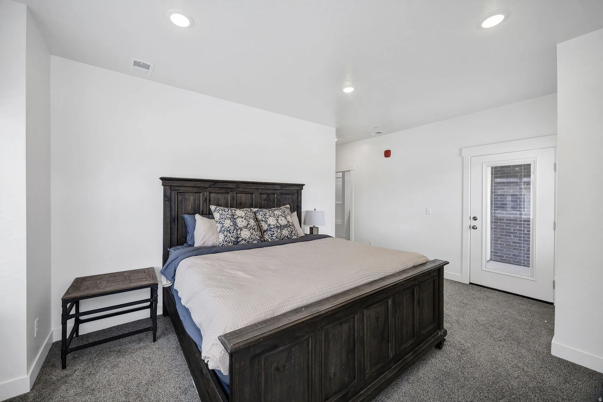 Carpeted room with recessed lighting and white walls