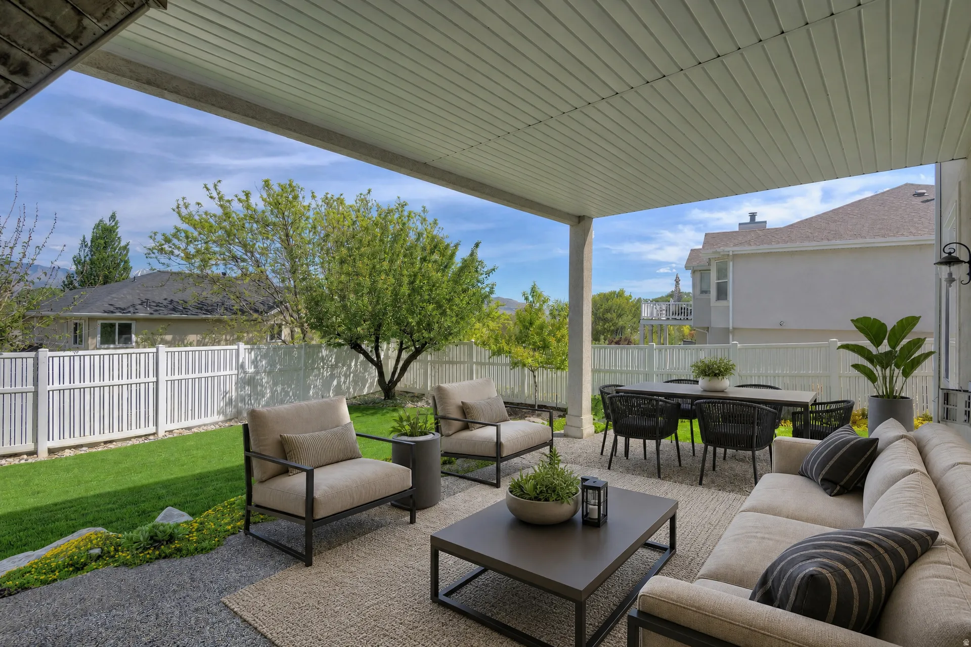 Covered patio featuring a slatted ceiling, a gravel base, and a woven area rug