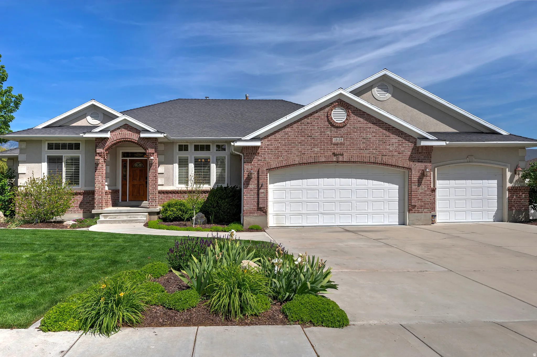 Brick and stucco exterior with multiple gables