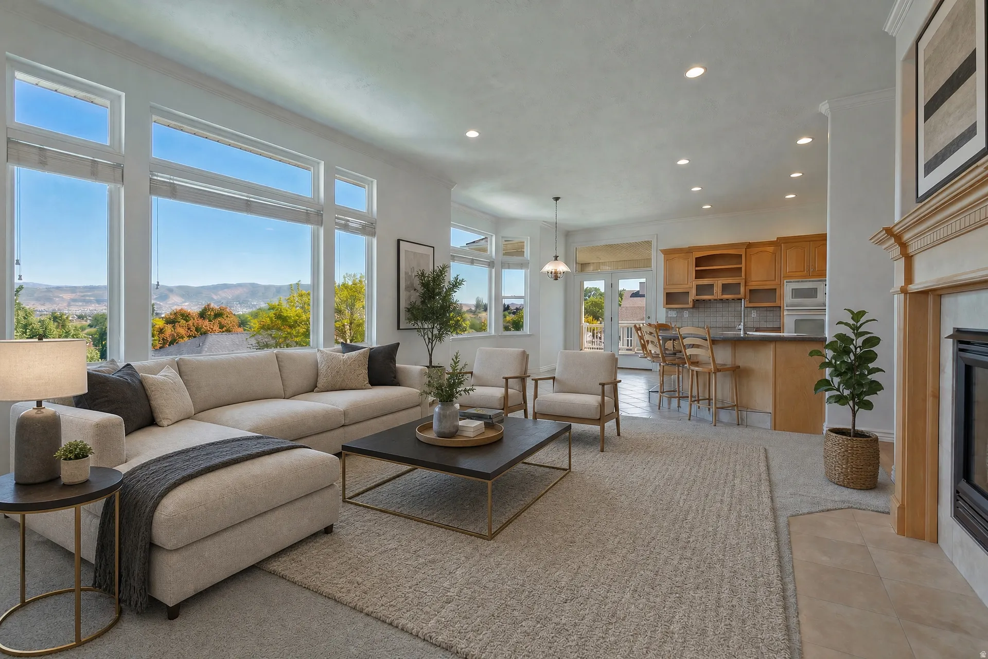 Spacious living area featuring extensive window walls, recessed lighting, a fireplace with a decorative mantel, light-toned carpeting, and an integrated kitchen with wood cabinetry