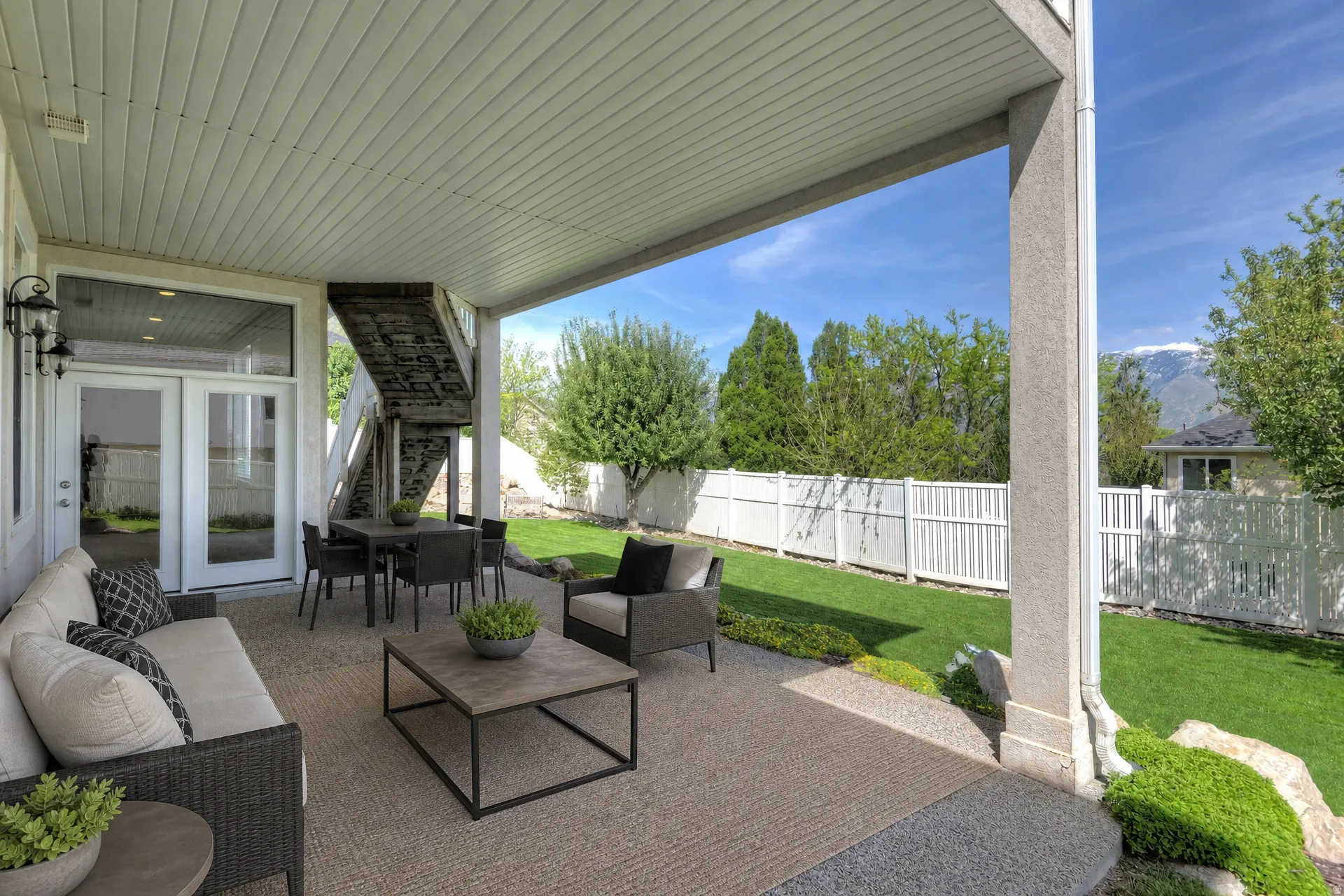 Covered patio area featuring a concrete surface and a partial area with a textured rug