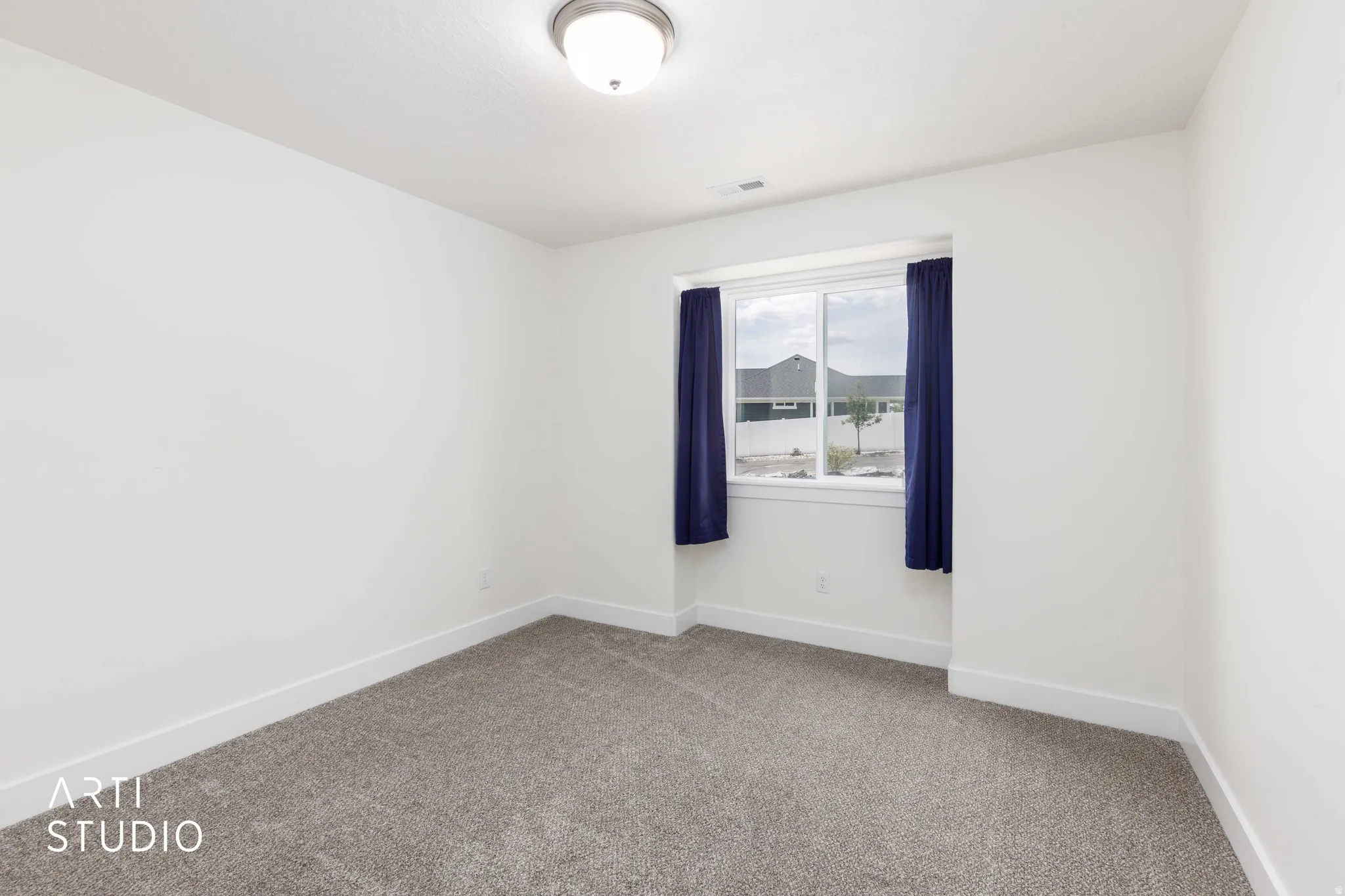 Room featuring neutral carpeting, white walls, and a window with a white frame