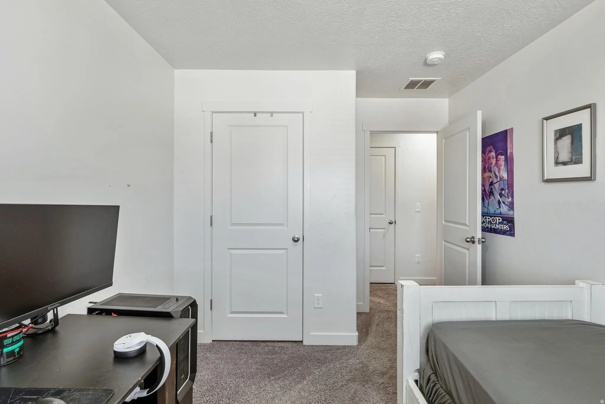 Carpeted room with white walls, white trim, and white two-panel doors