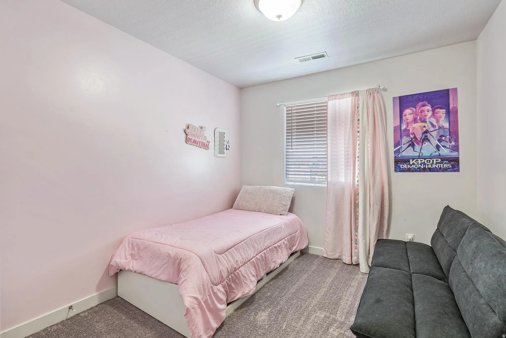 Room featuring light-toned walls, a window with horizontal blinds, and a built-in ceiling light fixture