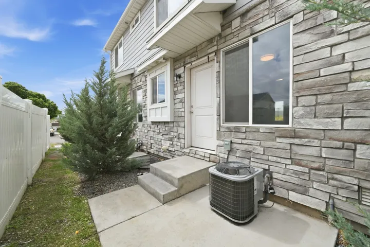 Stone veneer and siding exterior with concrete patio
