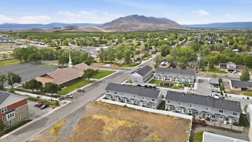 Aerial perspective showcasing a residential area with mountains in the background