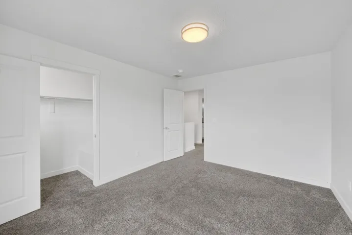 Room featuring neutral gray carpeting and white walls