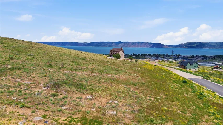 Expansive sloped lot with a paved road frontage