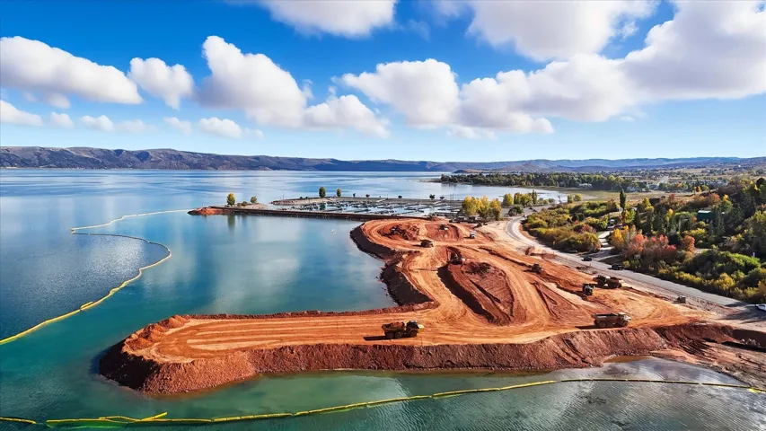 Lakeside property under development with significant earthwork, offering direct water access and waterfront frontage