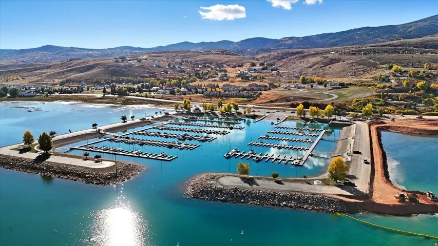 Expansive marina featuring multiple boat slips, rock breakwaters, and a boat launch ramp