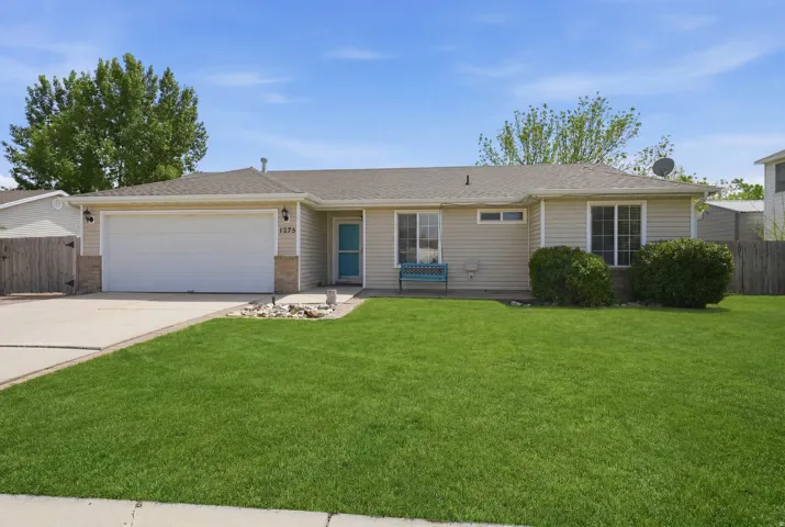 Ranch-style residence featuring beige siding, a two-car garage